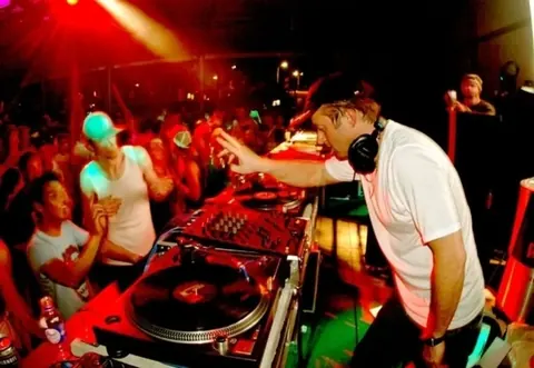 Freddy Fresh at the turntables in a packed club