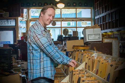 Freddy Fresh digging through crates in a record store