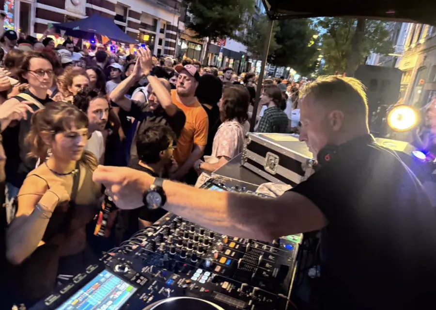 DJ Freddy Fresh mixing for a packed outdoor crowd